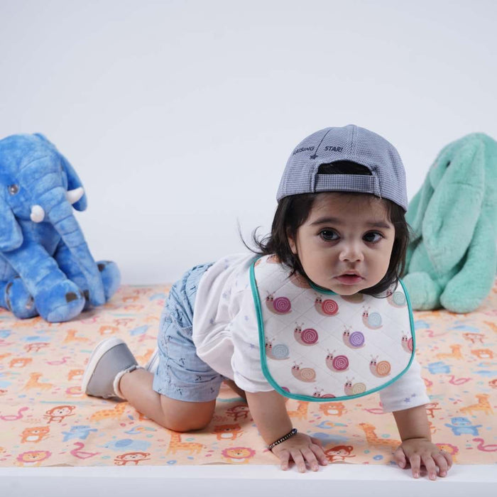 Baby playing on the animal-print waterproof crib sheet
