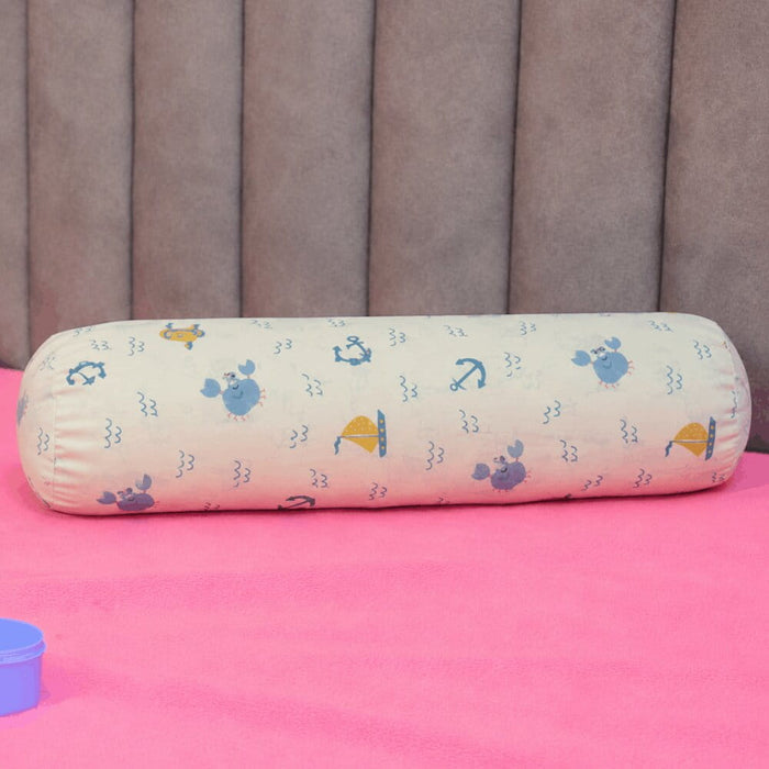 Happy Matty Nautical Print Cuddle Bolster Pillow on a Baby Bed